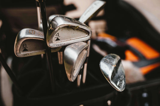 Dirty Titleist Golf Clubs in a bag | Photo by Will Porada on Unsplash