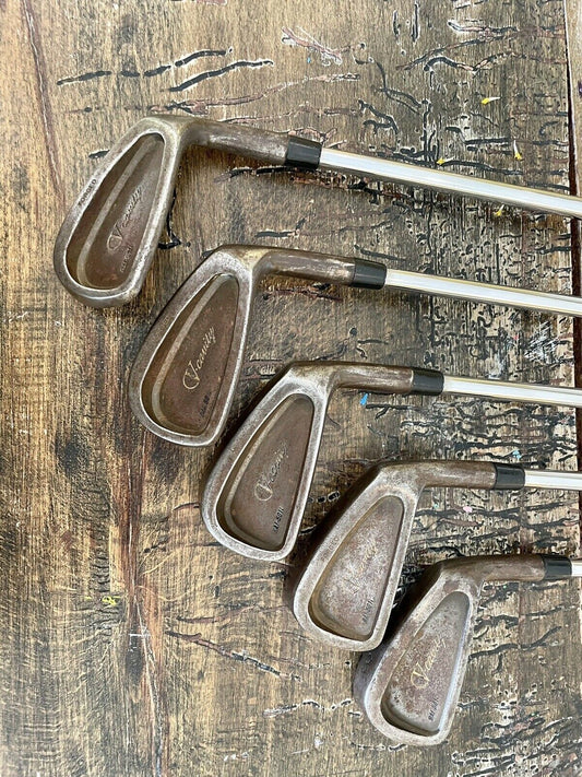 Half-set of 5 patina Vega Golf Clubs on a wooden background