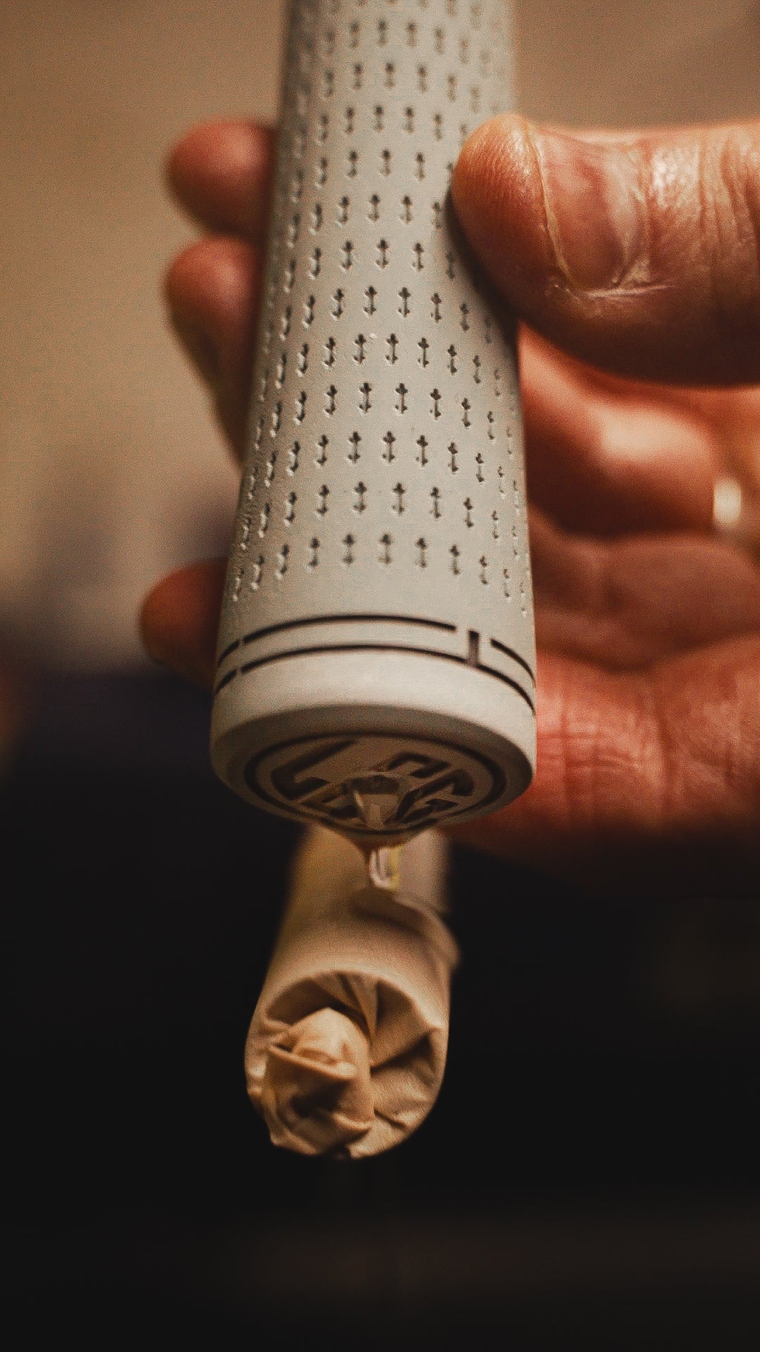 Regripping a Golf Club with Low Chaser Golf grips. Solvent being poured from the grip onto the tape on the shaft.