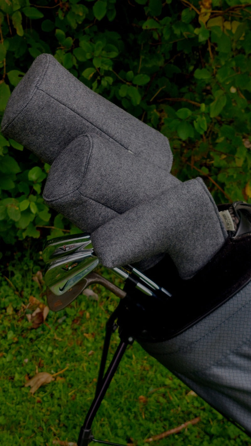 Charcoal headcovers, in a golf bag with bladed golf clubs