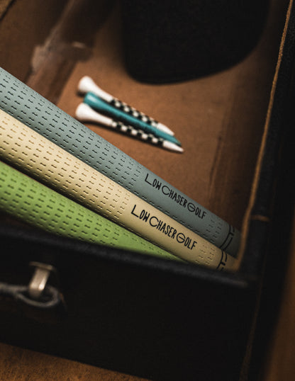 Cream, green and blue grips set in a dark suitacase